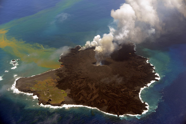 This handout picture taken by Japan Coast Guard on July 23, 2014 shows the newly created islet (R) and Nishinoshima island (L), which are conjoined with erupting lava at the Ogasawara island chain, 1,000 kilometres south of Tokyo. A smouldering islet off Japan's Pacific coast has grown six times in its land surface since before it merged last December with a landmass created by volcanic eruptions. AFP PHOTO / JAPAN COAST GUARD---EDITORS NOTE---HANDOUT RESTRICTED TO EDITORIAL USE - MANDATORY CREDIT "AFP PHOTO / JAPAN COAST GUARD" - NO MARKETING NO ADVERTISING CAMPAIGNS - DISTRIBUTED AS A SERVICE TO CLIENTS